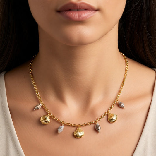 Aramat Jewels gold-tone necklace with real shell charms and small striped shells, 40+5 cm length, on a woman's neck.