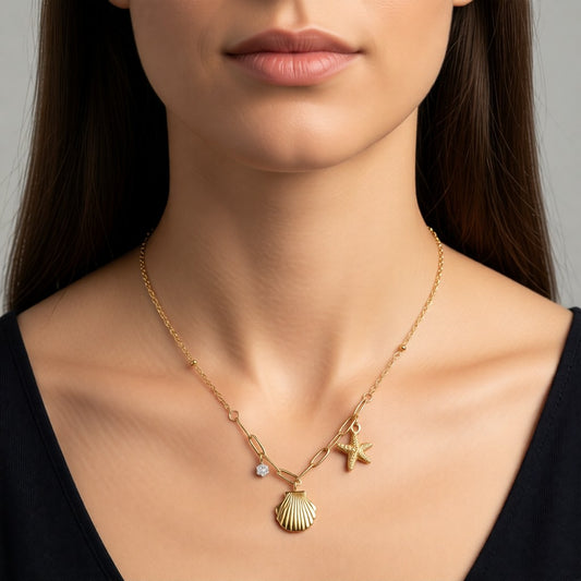Aramat Jewels gold-tone stainless steel necklace with shell, starfish, and cubic zirconia charms, 40+5 cm adjustable length.