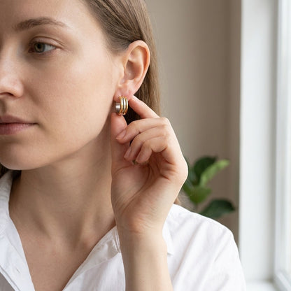 Aramat Jewels bicolor hoop earrings with gold and silver stripes, 13mm diameter, made of stainless steel.