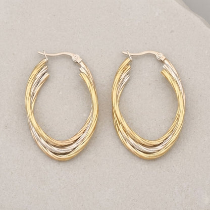 Aramat Jewels oval hoop earrings in gold and silver tones with a twisted design. 38x6mm.