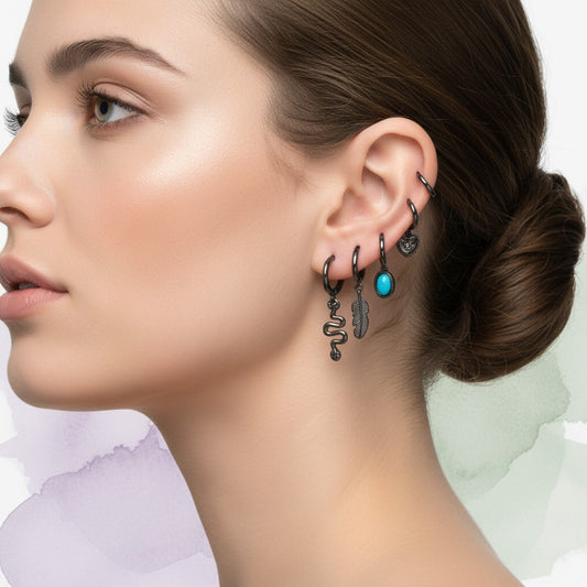 Aramat Jewels set of 6 black gun hoop earrings with charms: hamsa hand, feather, snake, heart, star, and turquoise stone.