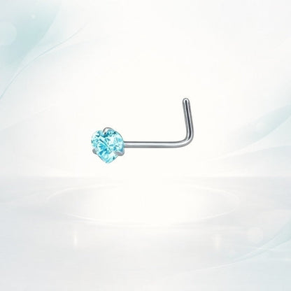 Aramat Jewels silver L-shaped nose stud with a small blue heart-shaped zirconia stone.
