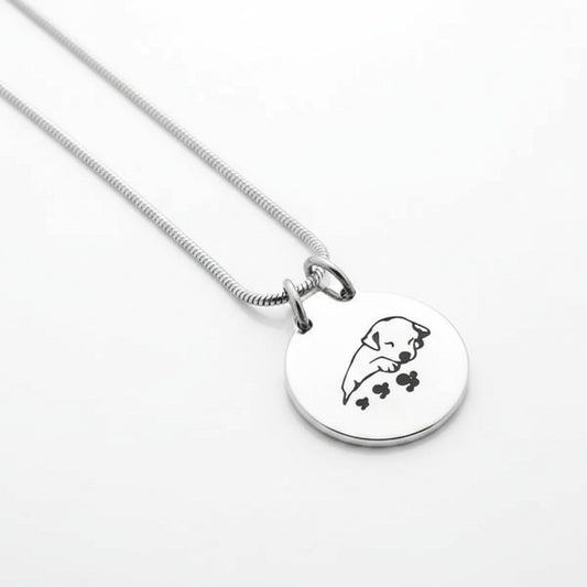 Aramat Jewels silver and black stainless steel dog ash pendant with chain, featuring a sleeping puppy design.