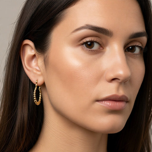 Aramat Jewels gold-tone stainless steel hoop earrings with a beaded design, 18mm diameter.