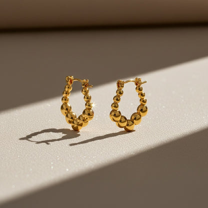 Aramat Jewels gold-tone stainless steel rectangular hoop earrings with a playful beaded pattern, 21x24mm.