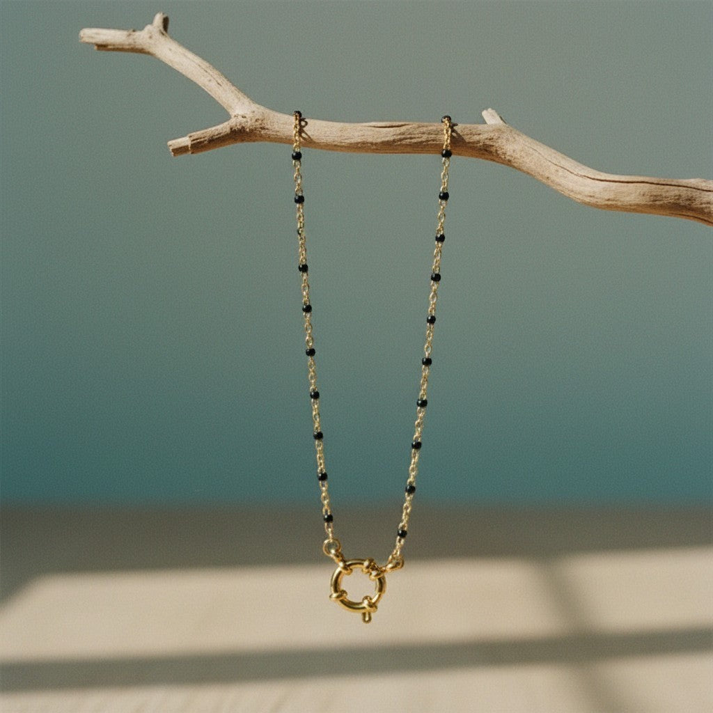 Aramat Jewels gold chain necklace with small black enamel beads and a unique gold clasp.