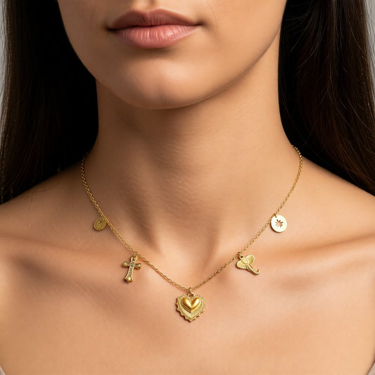 Aramat Jewels gold-tone stainless steel necklace with crystal-embellished cross, heart, elephant, and disc charms.