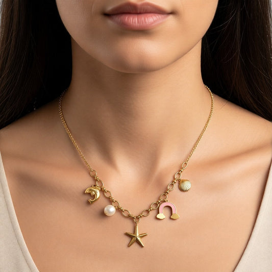 Aramat Jewels gold-tone stainless steel necklace with charms: dolphin, pearl, starfish, pink enamel horseshoe, and seashell.