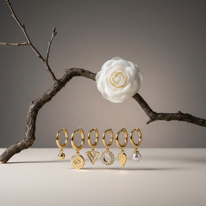 Aramat Jewels set of 6 gold-plated 925 silver hoop earrings with charms: pearl, evil eye, triangle, sunburst, and teardrop.