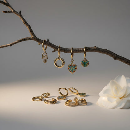 Aramat Jewels gold plated 925 silver earrings set with cubic zirconia, including hamsa hand, heart charm, and ear cuffs.