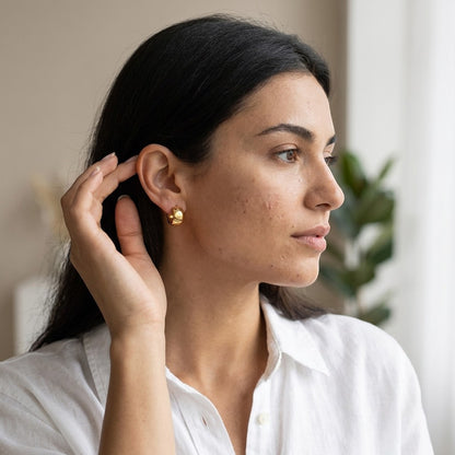 Aramat Jewels gold-tone stainless steel hoop earrings with Greek motif, 13mm diameter.