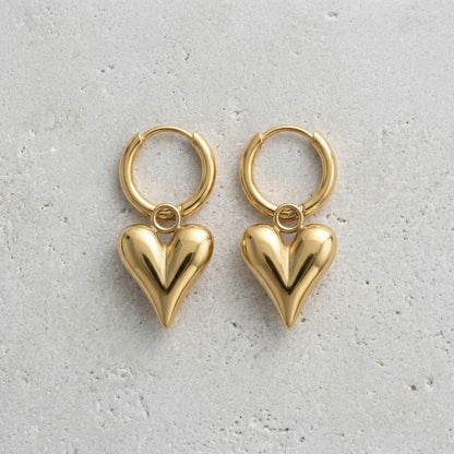 Aramat Jewels gold-tone stainless steel huggie hoop earrings with puffy heart charms.