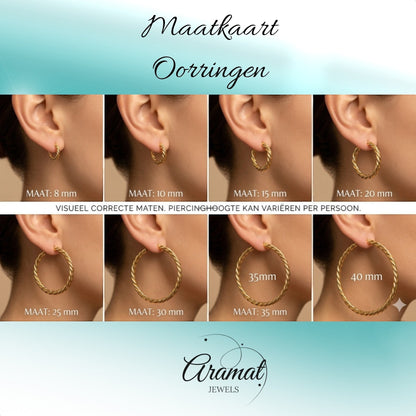Aramat Jewels gold-tone twisted hoop earrings, 16mm diameter, with an ethnic design, shown on a model's ear.