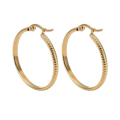 Aramat Jewels gold stainless steel hoop earrings with a textured dot pattern, 25mm diameter.