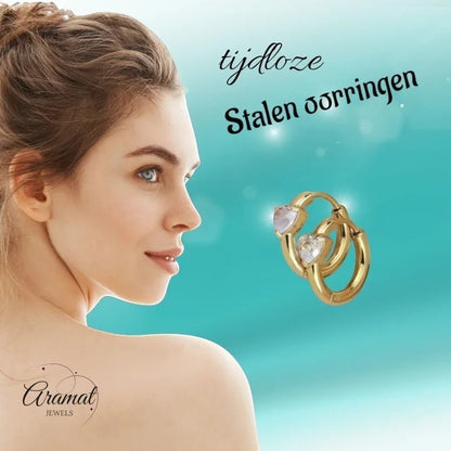 Aramat Jewels gold hoop earrings with heart-shaped zirconia, 15mm diameter, 7mm stone. Model shown from the side.