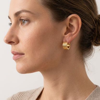 Aramat Jewels gold-tone stainless steel hoop earrings with triple stripe detail, 13mm or 20mm diameter.