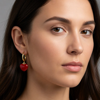 Aramat Jewels gold huggie hoop earrings with a red enamel heart charm, 14mm hoops with 12mm heart pendant.