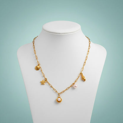 Aramat Jewels gold-tone necklace with shell, starfish, and pearl charms. Features a link chain and a sea-themed design.