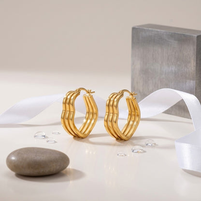 Aramat Jewels gold-colored triple heart hoop earrings, 25mm, made of stainless steel with a smooth finish.