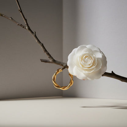 Aramat Jewels gold-coloured stainless steel hoop earrings with a twisted and diamond pattern design, 30mm diameter.