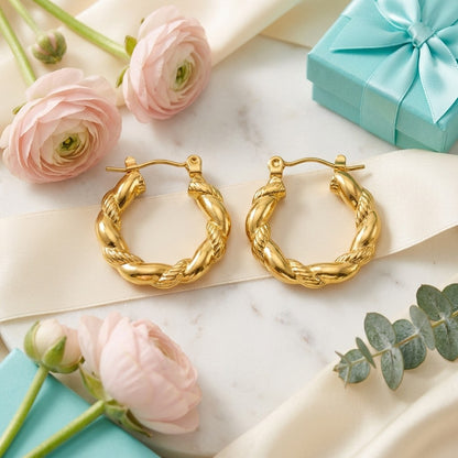Aramat Jewels gold-colored stainless steel twisted hoop earrings, 22mm diameter, with a unique braided design.