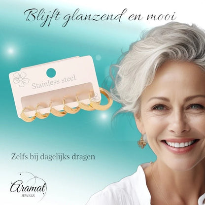 Aramat Jewels goudkleurige stainless steel huggie oorringen set in drie maten met een lachende vrouw op de achtergrond