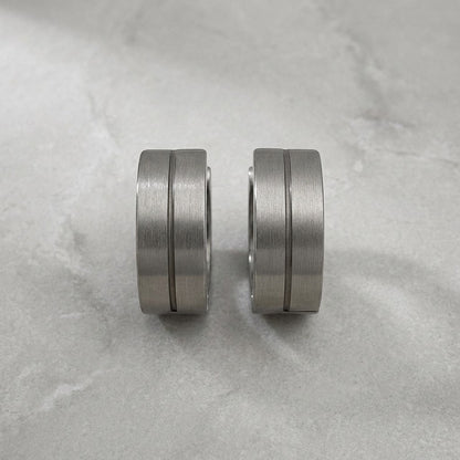 Aramat Jewels matte silver-tone stainless steel hoop earrings with a subtle glossy stripe detail, 13mm.
