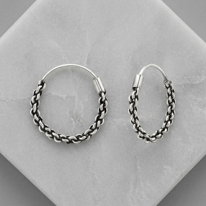 Aramat Jewels small silver Bali hoop earrings, 16mm, with intricate braided texture and ethnic design.