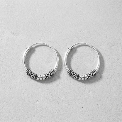 Aramat Jewels thin 16mm silver Bali hoop earrings with intricate tribal-inspired detailing, perfect for boho style.
