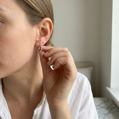 Aramat Jewels women's small 16mm silver Bali hoop earrings with a twisted rope design, worn by a model.