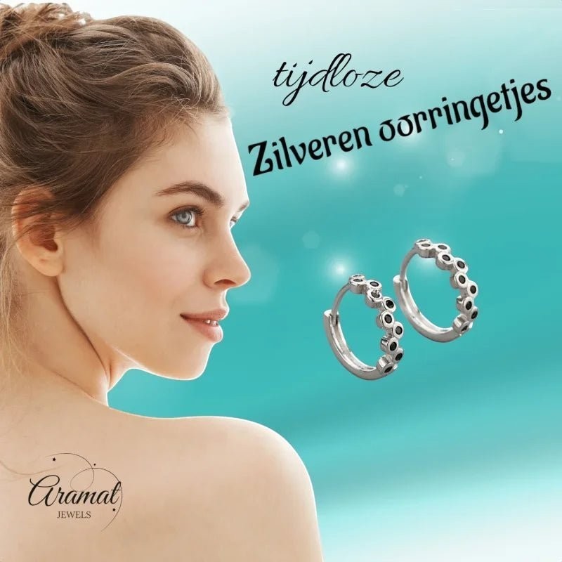 Aramat Jewels silver hoop earrings with black zirconia stones, 12mm diameter, on a model.