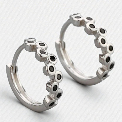 Aramat Jewels silver hoop earrings with black cubic zirconia stones, 12mm diameter.