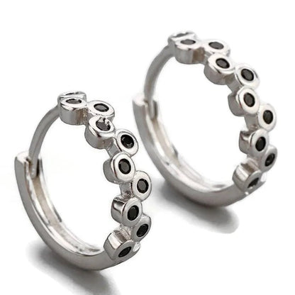 Aramat Jewels silver hoop earrings with black cubic zirconia stones, 12mm diameter.