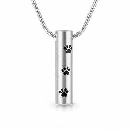 Aramat Jewels silver-colored stainless steel cylinder cremation pendant with black paw prints, 3.4cm