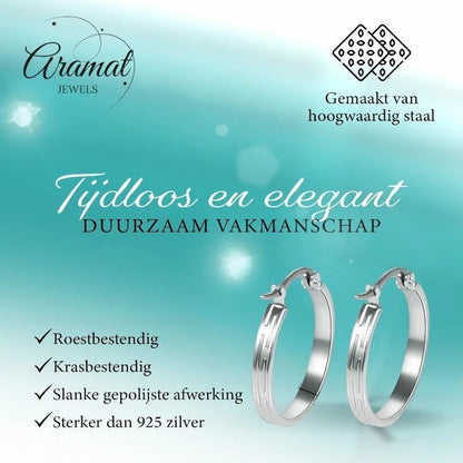 Aramat Jewels silver-tone stainless steel hoop earrings with a striped pattern, 20mm diameter.