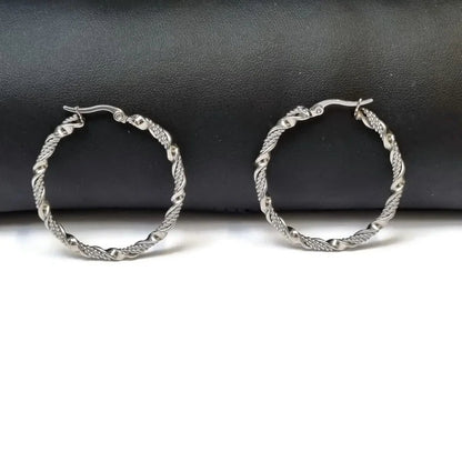 Aramat Jewels silver-tone stainless steel twisted hoop earrings, 30mm or 40mm diameter, 3mm width, with a secure clasp.