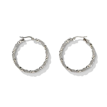Aramat Jewels silver-tone stainless steel twisted hoop earrings, 30mm or 40mm diameter, 3mm width, with a shiny finish and hinge closure.