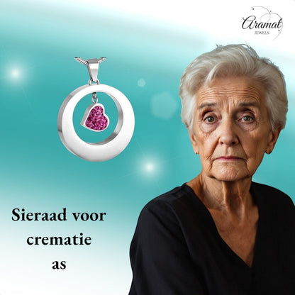 Aramat Jewels zilverkleurige stalen ashanger rond met een hartje bezet met roze kristallen.
