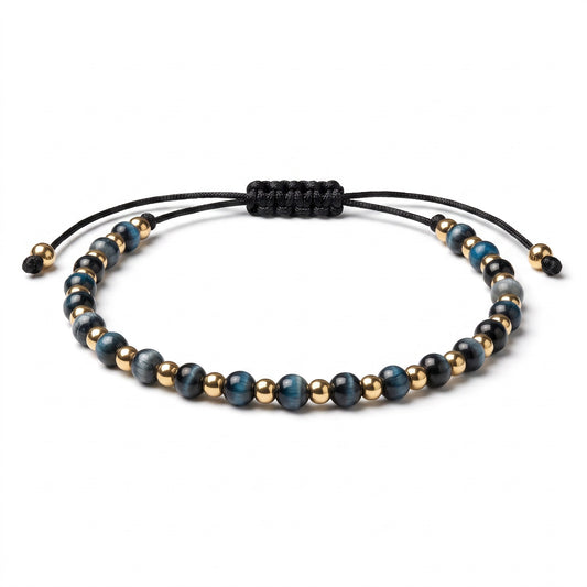 Aramat Jewels verstelbaar enkelbandje met blauwe cats eye kralen en goudkleurige accenten op een zwart touwtje.