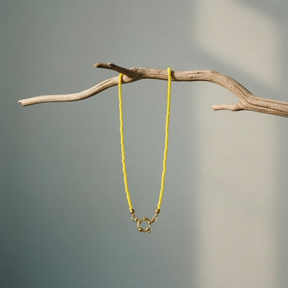Aramat Jewels yellow rocailles beaded necklace with gold clasp and accents, 42cm length.