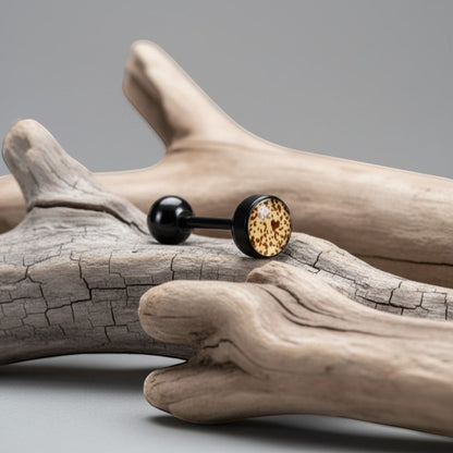 Aramat Jewels black bioplast tongue piercing with a tan and brown animal print design on the front ball.