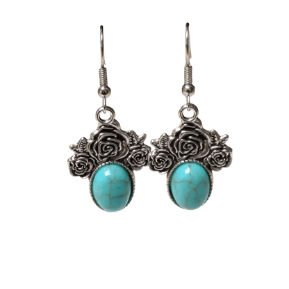 Paar zilveren oorbellen met turquoise stenen en roosmotieven.