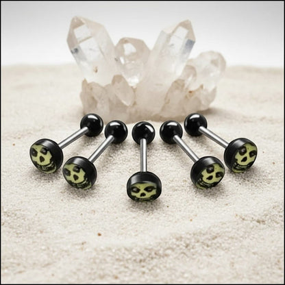 Aramat Jewels surgical steel tongue piercing with black acrylic balls and a skull logo design.