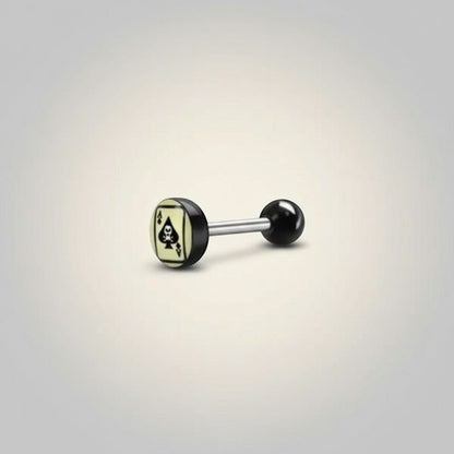 Aramat Jewels surgical steel tongue piercing with black acrylic balls and a spade card logo on a light yellow background.