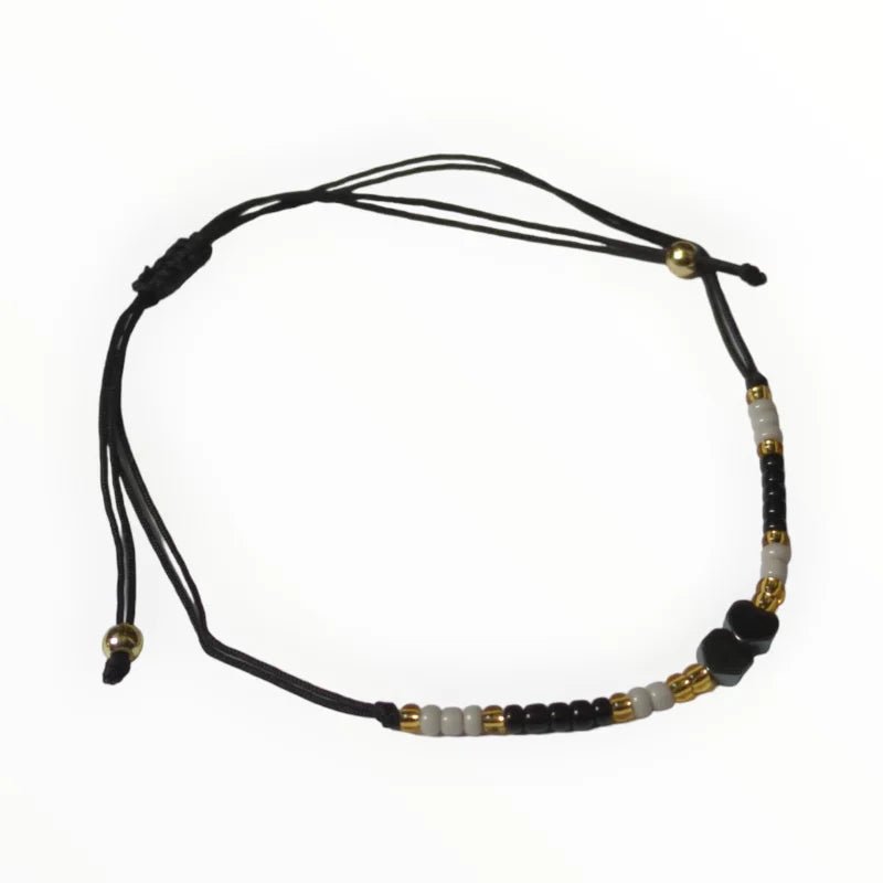 De zwarte en gouden armband