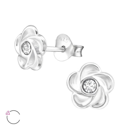 Een paar zilveren oorbellen met een bloemmotief en een diamant