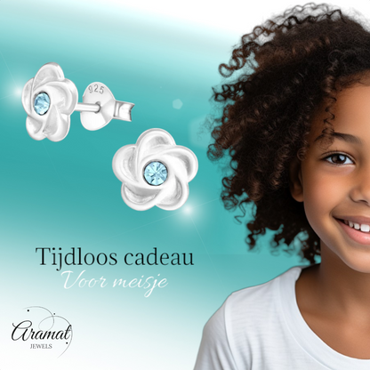 Silver flower stud earrings with blue crystals