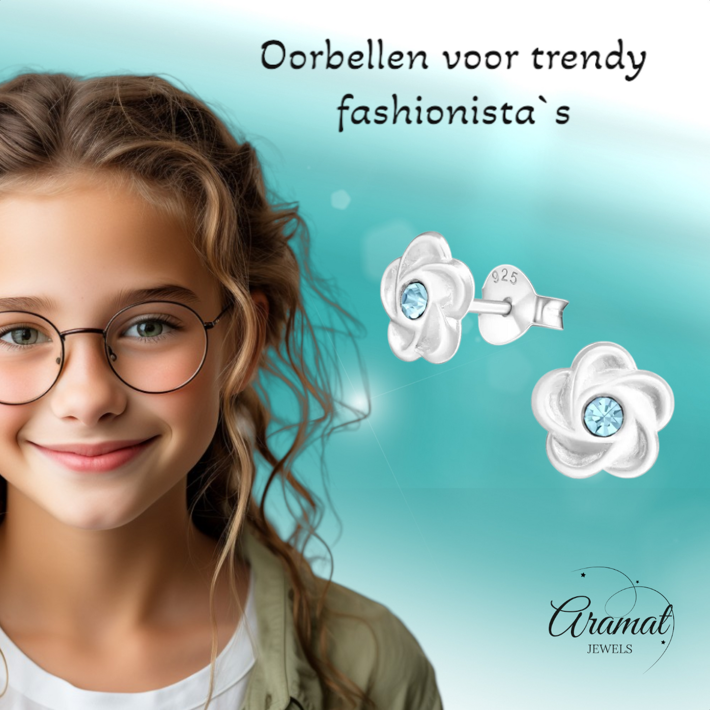 Silver flower stud earrings with blue crystals