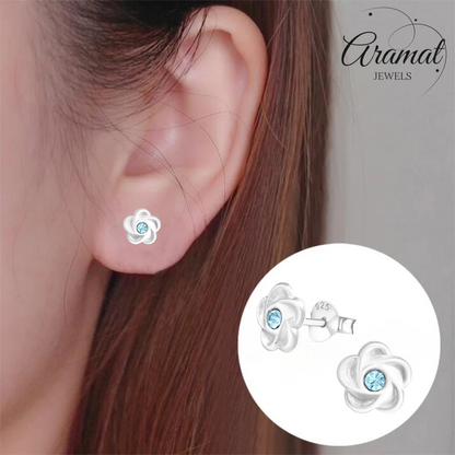 Silver flower stud earrings with blue crystals