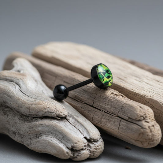Aramat Jewels black bioplast tongue piercing with a green and yellow camouflage design on the top ball.
